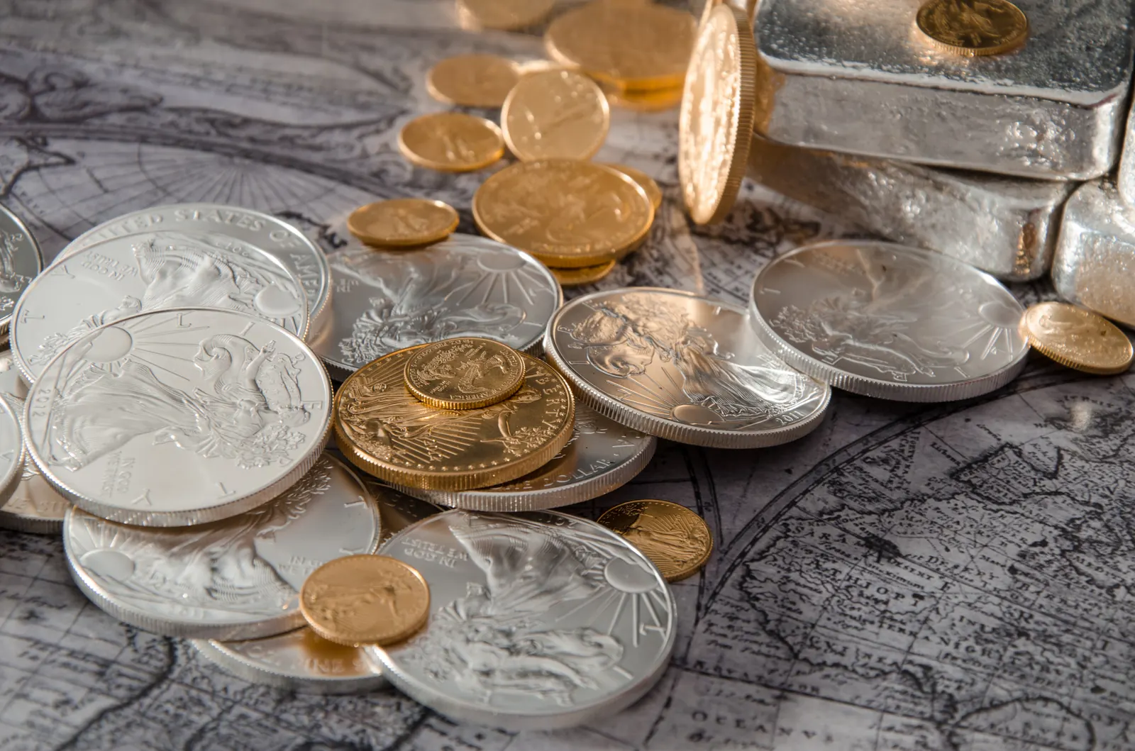 Gold and silver coins arranged on an antique map of the United States