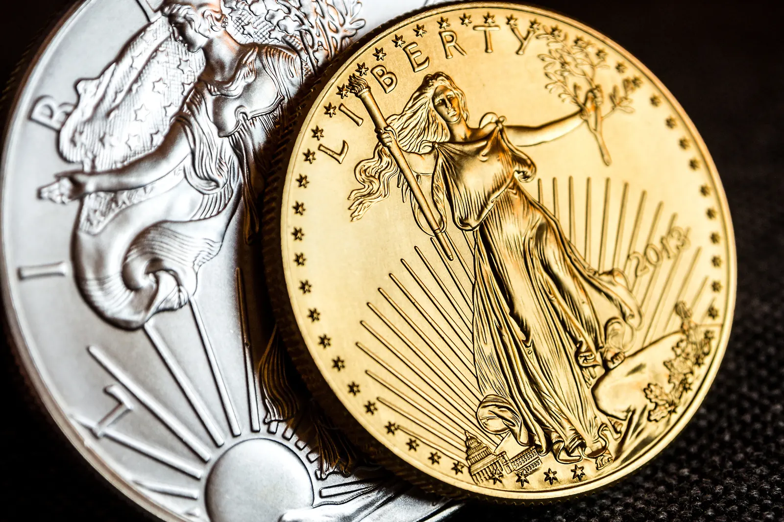 American Gold Eagle and Silver Eagle coins side by side