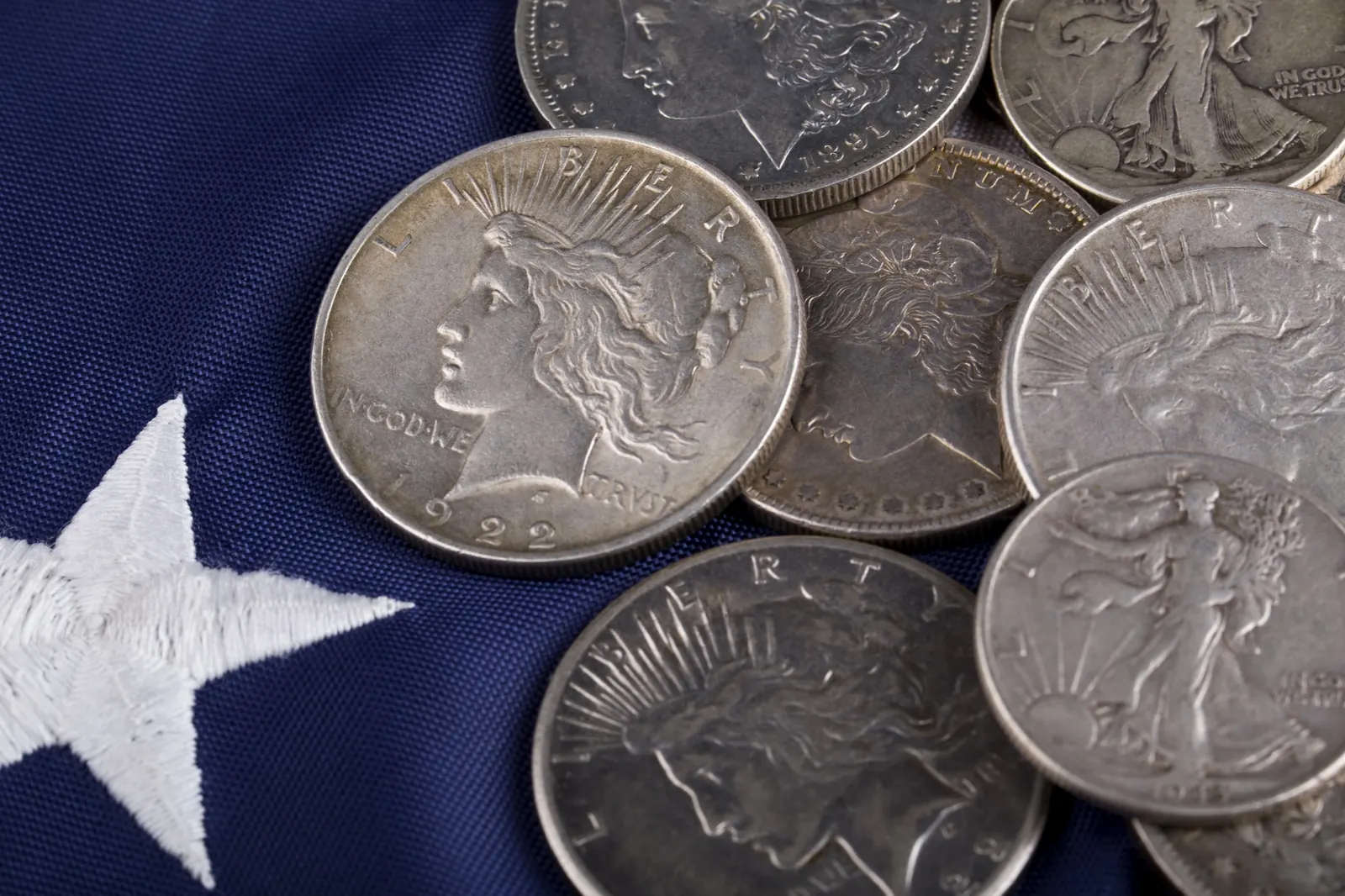 Peace silver dollar resting on a US flag