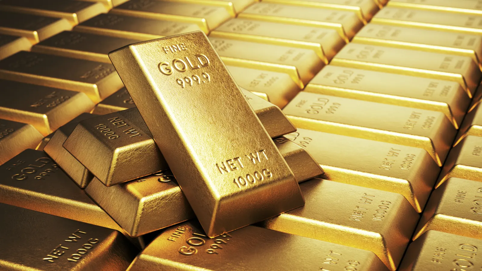 Stack of gold bars on a dark surface at an Arlington coin and bullion shop
