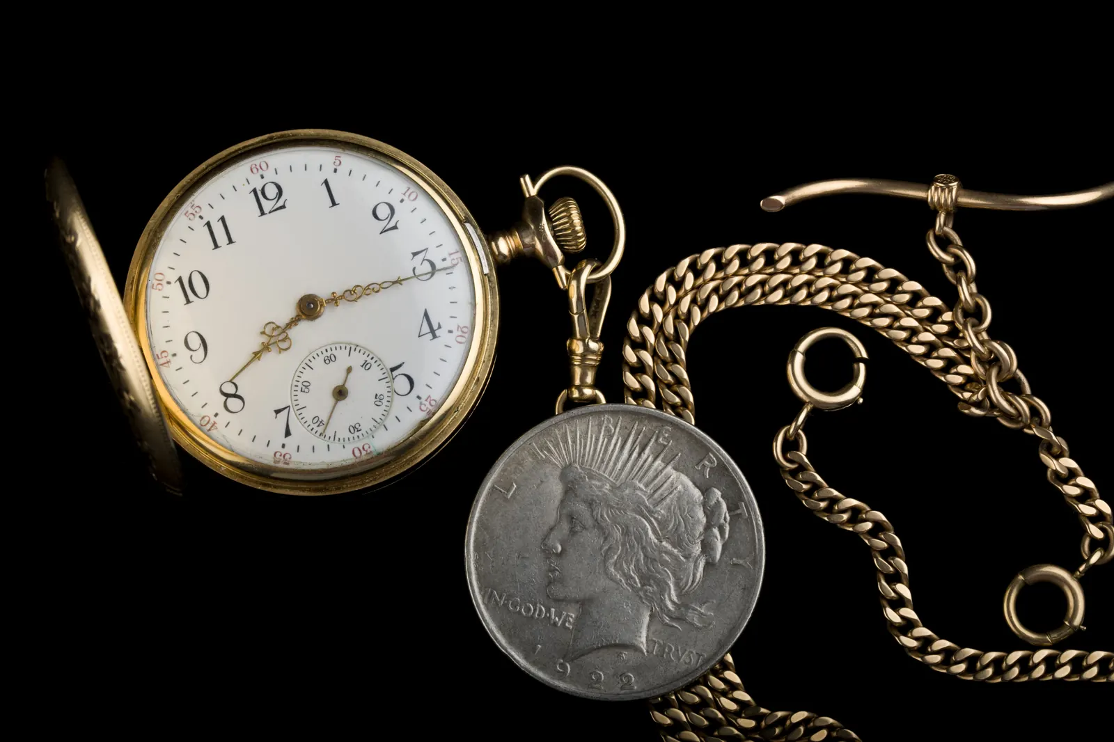 Antique pocket watch from 1917 paired with a vintage US silver dollar
