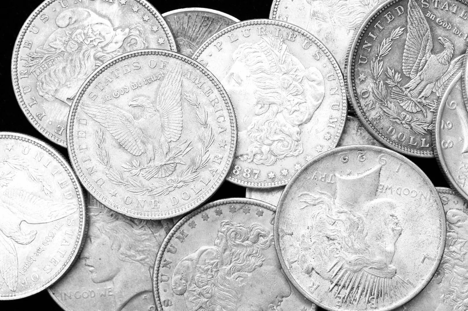 Detailed photograph of US Silver Dollars on black background